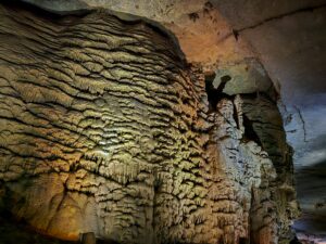 Flowstone wall with a caveman figure